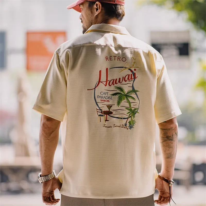 Light apricot men's shirt with bamboo pattern and Cuban collar shown on hanger