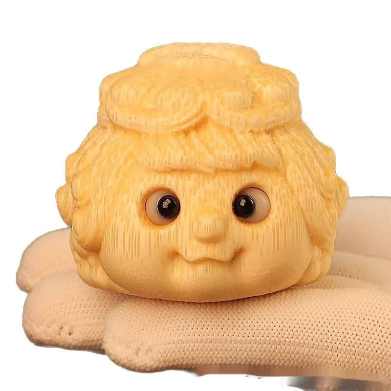 Solid bamboo carving of a cute golden toad princess ornament, 5 cm tall, on a plain background.