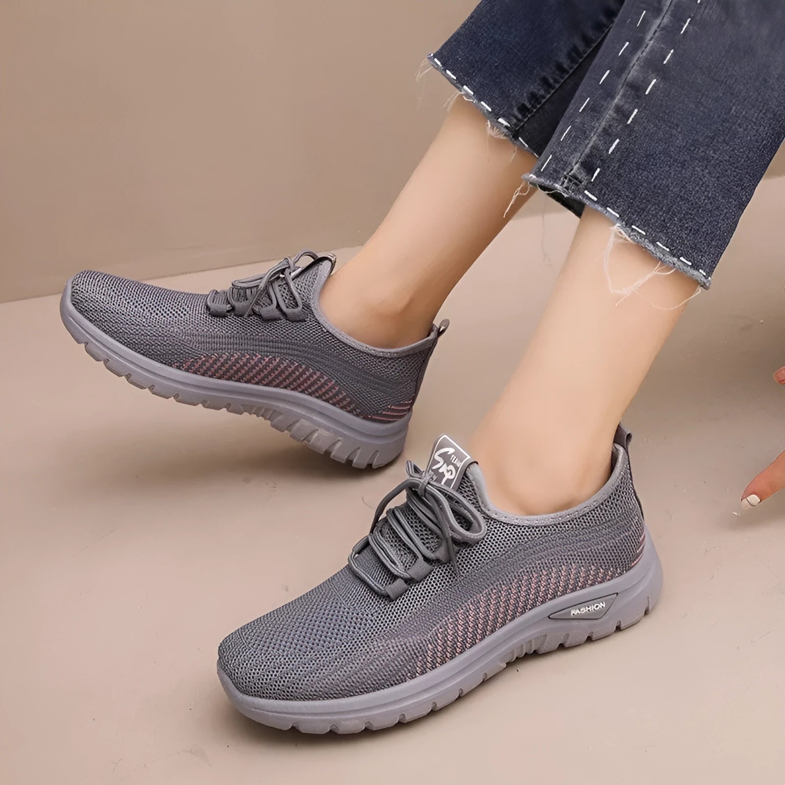 Women's low-top mesh sneakers in black, gray, or purple with round toe, cross straps, and rubber sole.