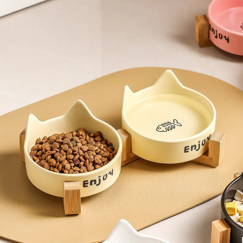 Porcelain cat food and water bowl set with wooden anti-slide frame in a choice of colours and patterns.
