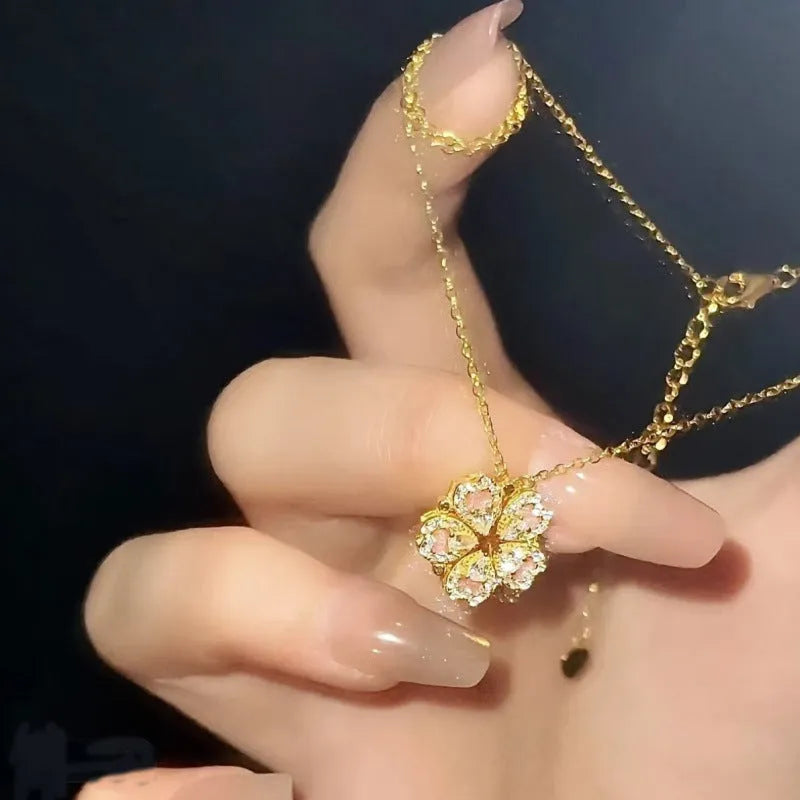 Dual-wear summer mori necklace with copper heart pendant and flower elements in gold colour on woman