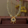 Women's green double-layer bracelet with safety lock pendant in drop shape design