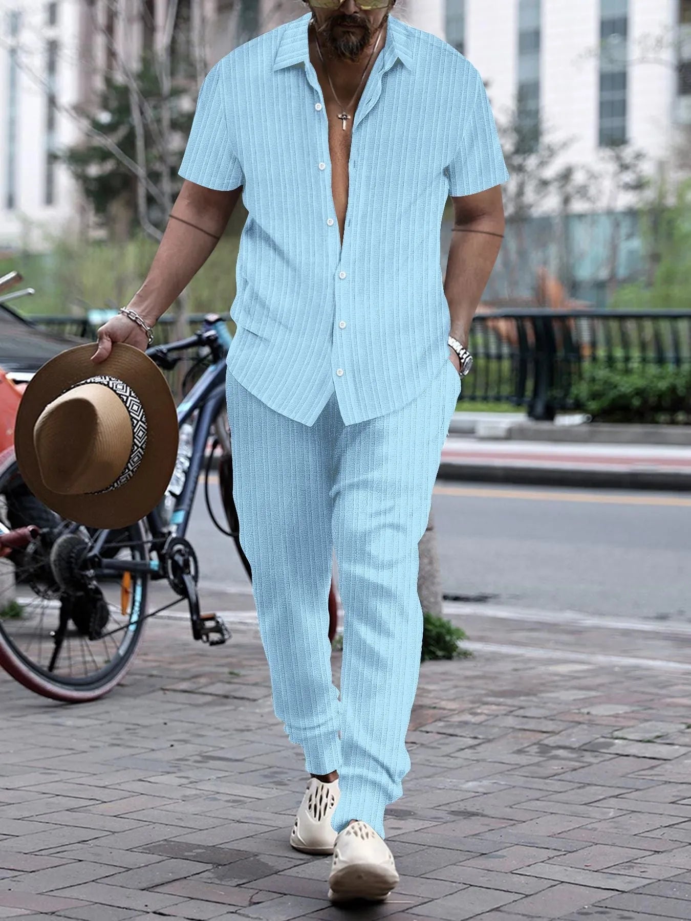 Men's loose fit casual beach suit set in cotton blend fabric, showing short sleeve shirt and trousers.