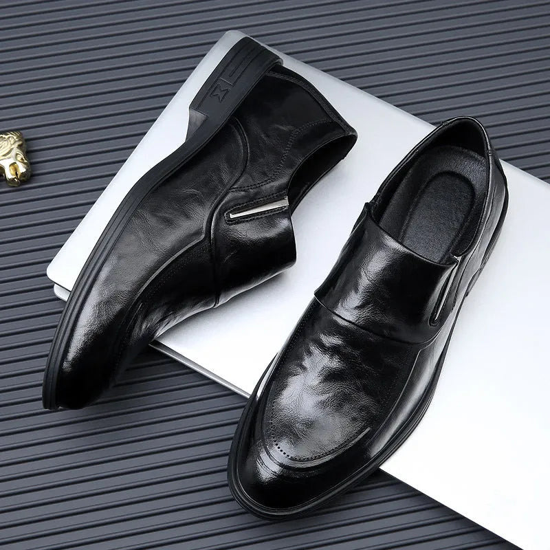 Men's black cowhide leather slip-on casual shoes with rubber sole on a plain background