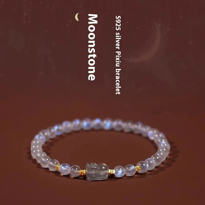 Close-up of a moonstone bracelet with a carved animal or zodiac design, showing grinding finish and blue light trend detail.