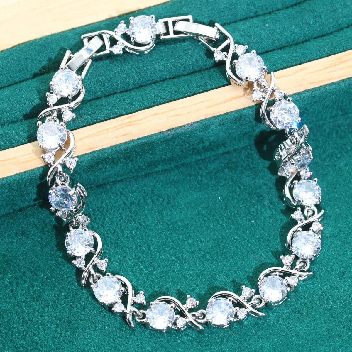 Four-piece bridal jewellery set with zircon details, water wave chains, and alloy pendants in presentation