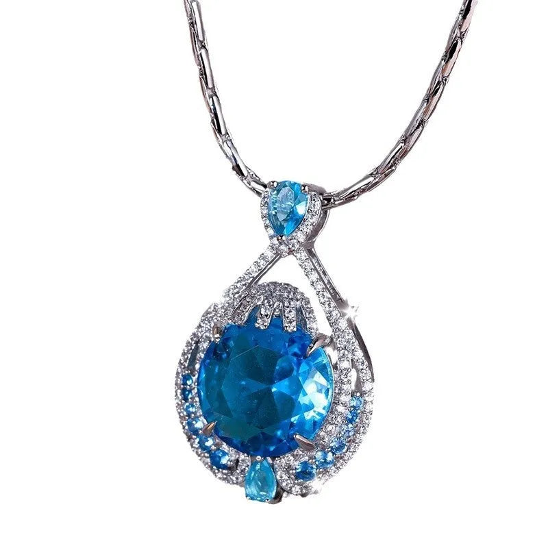 Blue geometric necklace with fireworks-cut crystal pendant on water wave chain