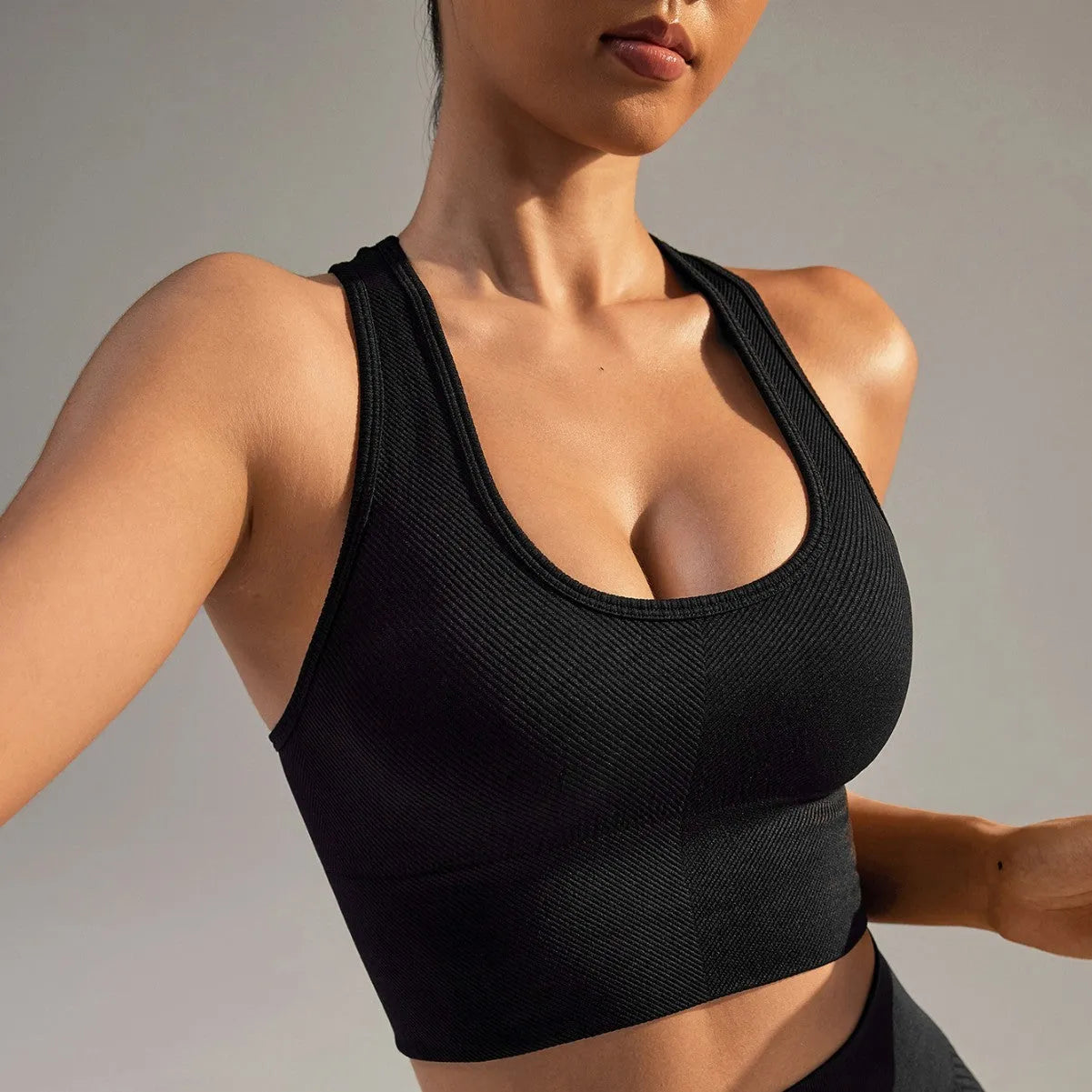 Black cross-back sports bra with quick-dry nylon fabric for running and yoga support