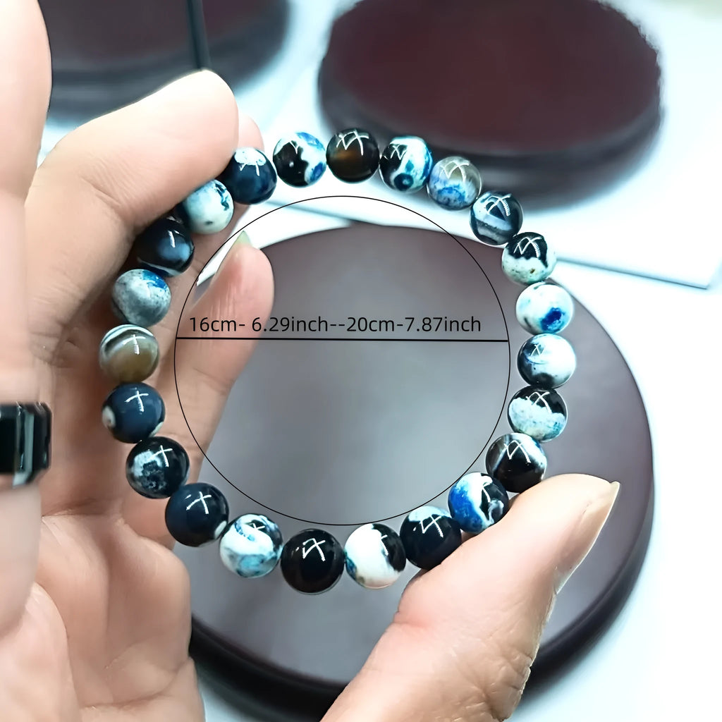 Close-up of a bohemian-style bracelet with 8mm natural agate beads and glass accents on a wrist.