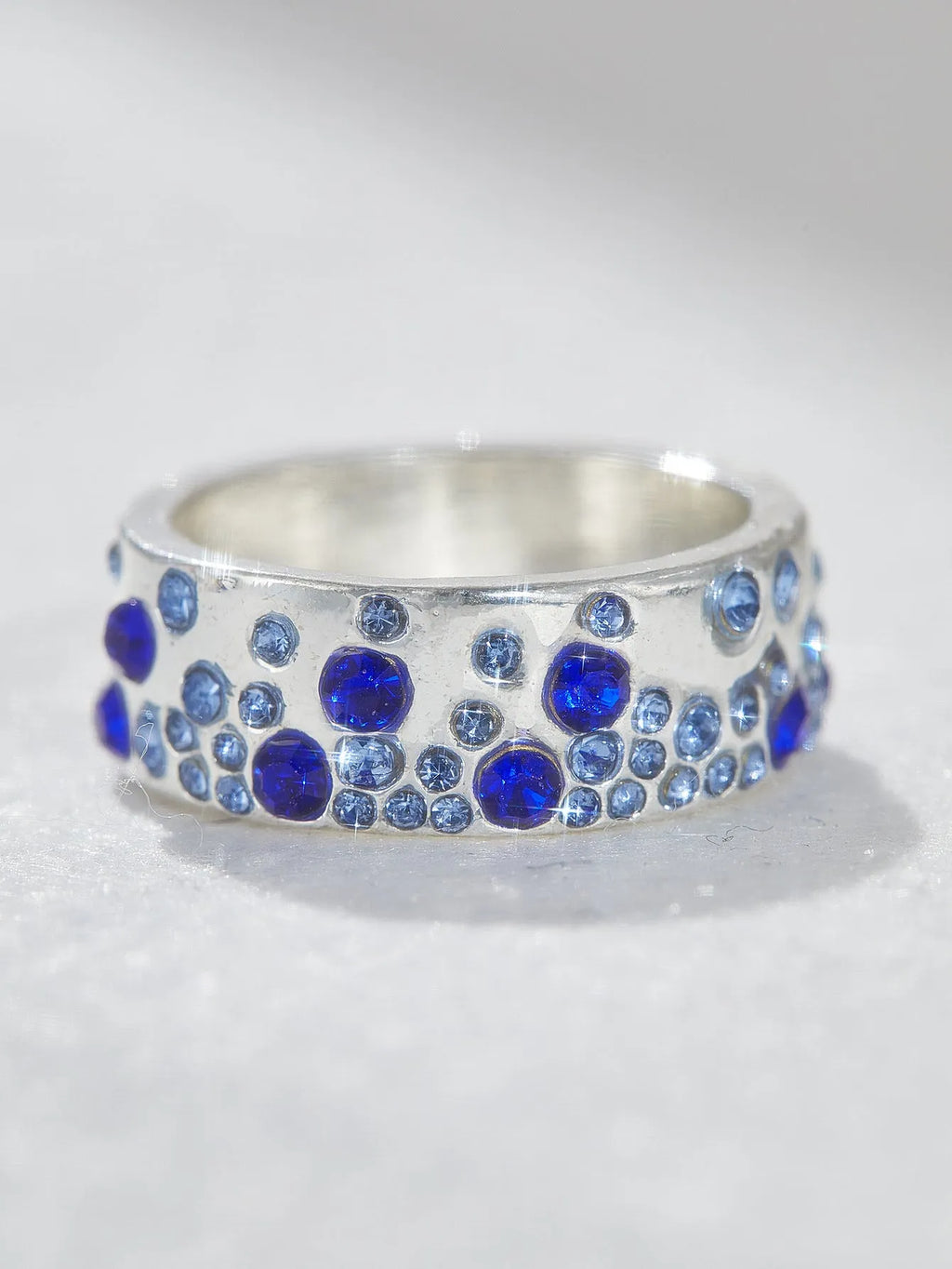 Mixed colour diamond retro personality ring in unisex geometric style on a white background.
