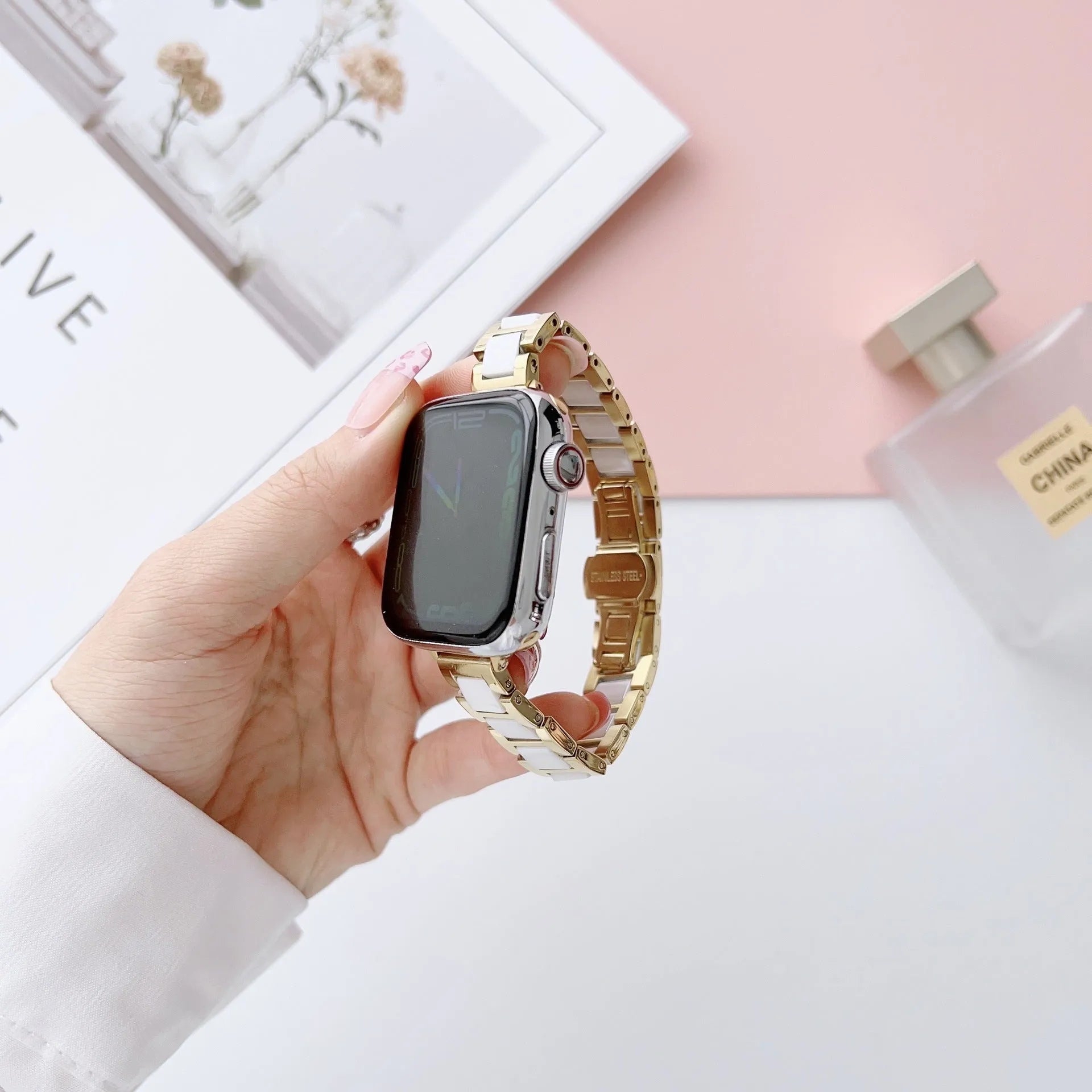 Stainless steel ceramic watch band for Apple Watch 38-49mm in gold with black ceramic finish on a wrist