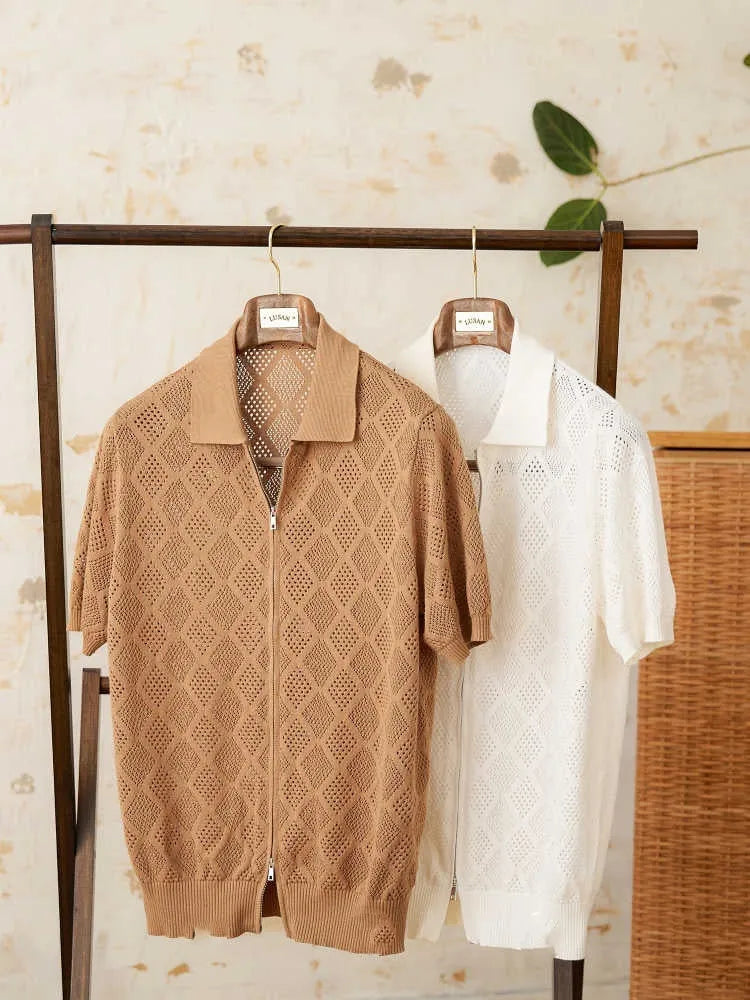 Light brown short sleeve cotton cardigan with a front zipper and lapel collar laid flat.