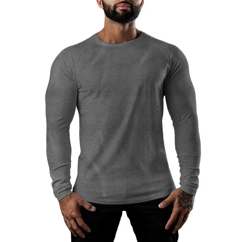 Man wearing a grey long sleeve cotton sports t-shirt with a round neck.