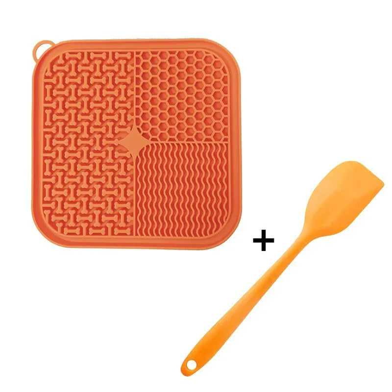 Square orange silicone dog licking mat with textured surface and suction cups on back.