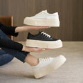 Women's black embossed cowhide platform sports board shoes with a rubber sole.