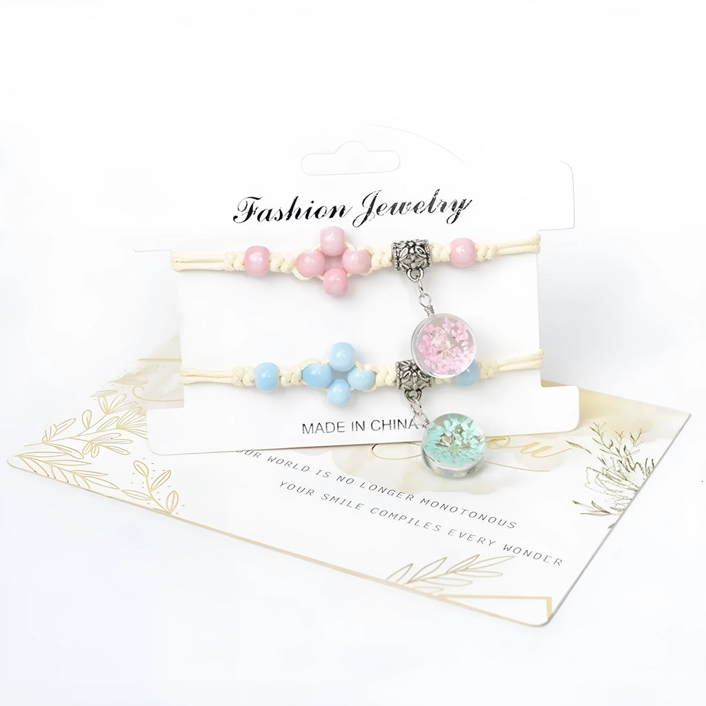 Hand-woven glass bracelet with large beads containing dried flowers and lace decorations, shown in blue.