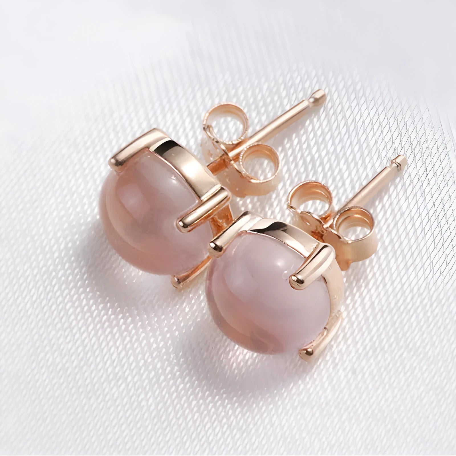 Rose gold drop shape stud earrings with synthetic Ross quartz crystal inlay