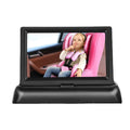 Black 4.3-inch folding screen car baby monitor with rear view camera on vehicle dashboard