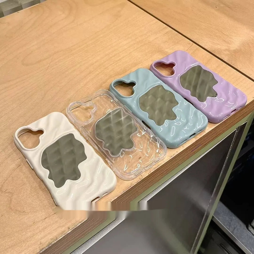 Solid colour phone case with a built-in mirror for iPhone models, shown in beige and purple.