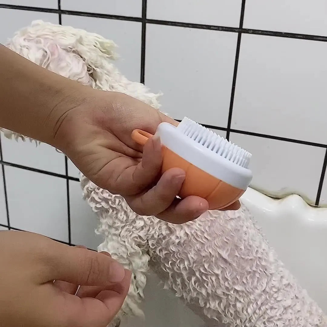Orange TPR dog bath brush with shampoo dispenser, massage bristles and comb teeth.