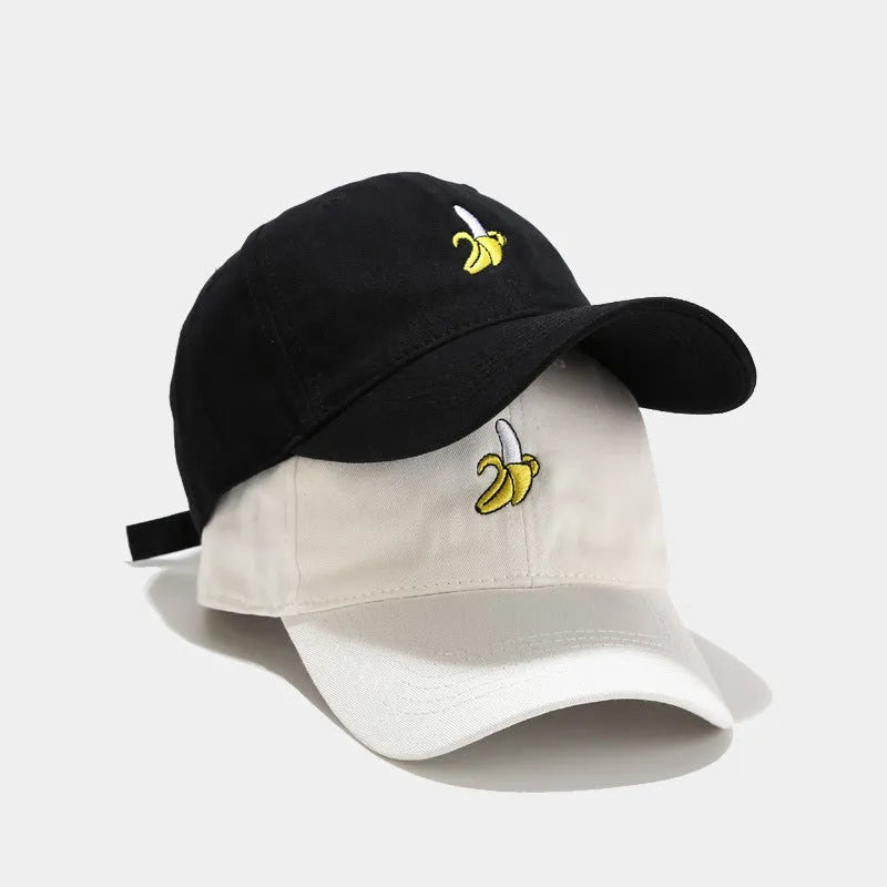 Adjustable black baseball cap with white banana embroidery on the front.