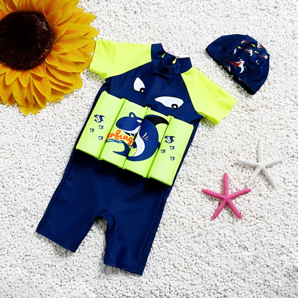 Child wearing a Shark Boy cartoon design buoyancy swimsuit in a swimming pool.