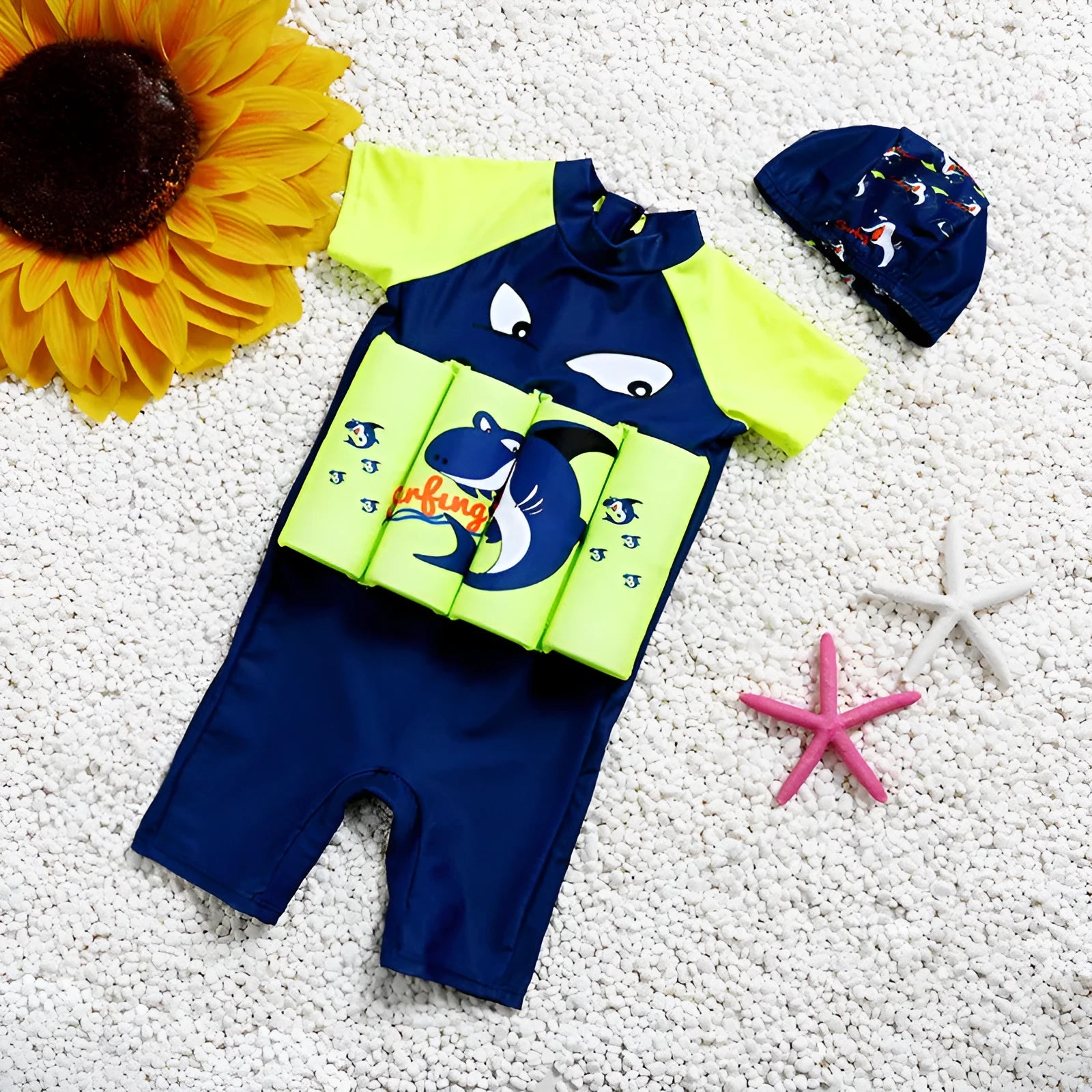 Child wearing a Shark Boy cartoon design buoyancy swimsuit in a swimming pool.