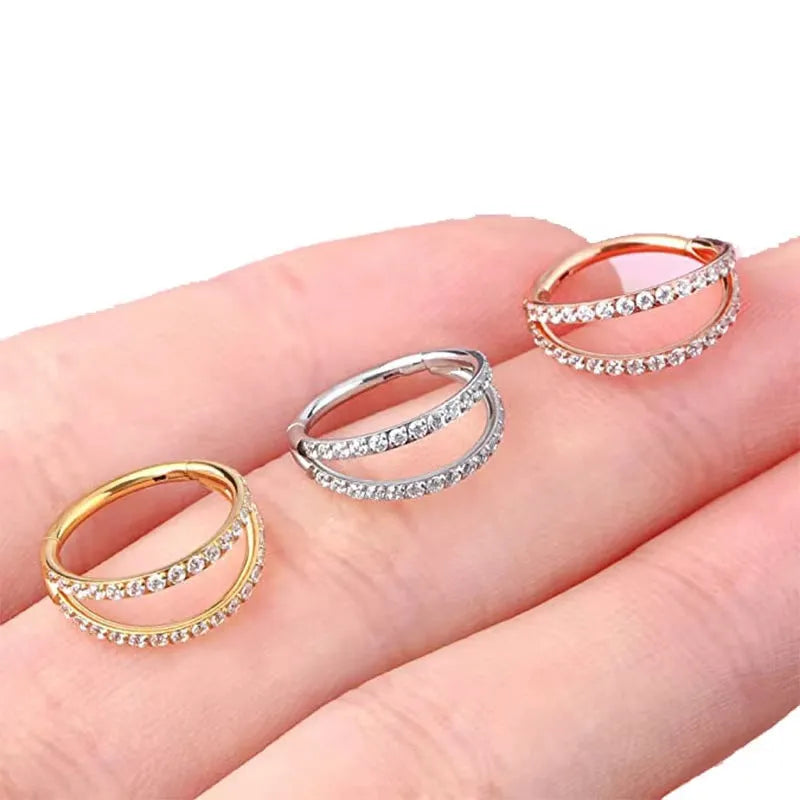 Close-up of a G23 titanium alloy lip ring with a diamond zircon finish in gold colour.