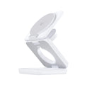 White foldable magnetic wireless charger and phone holder on a desk