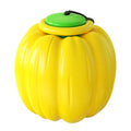 Pumpkin-shaped orange dog chew ball with squeaker for small dogs on a wooden floor.