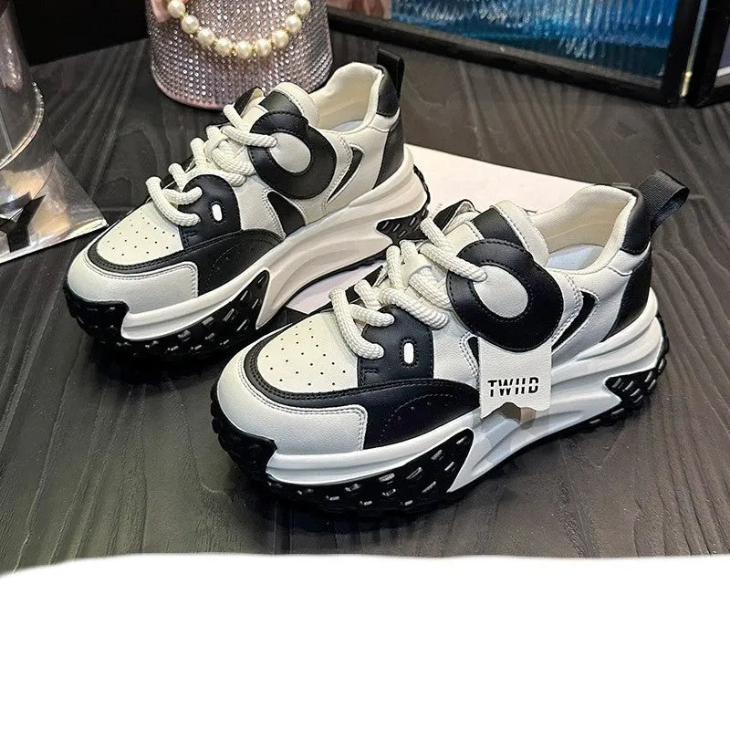 Men's thick-soled leather casual shoes in black and white colour with round toe and lace-up front.