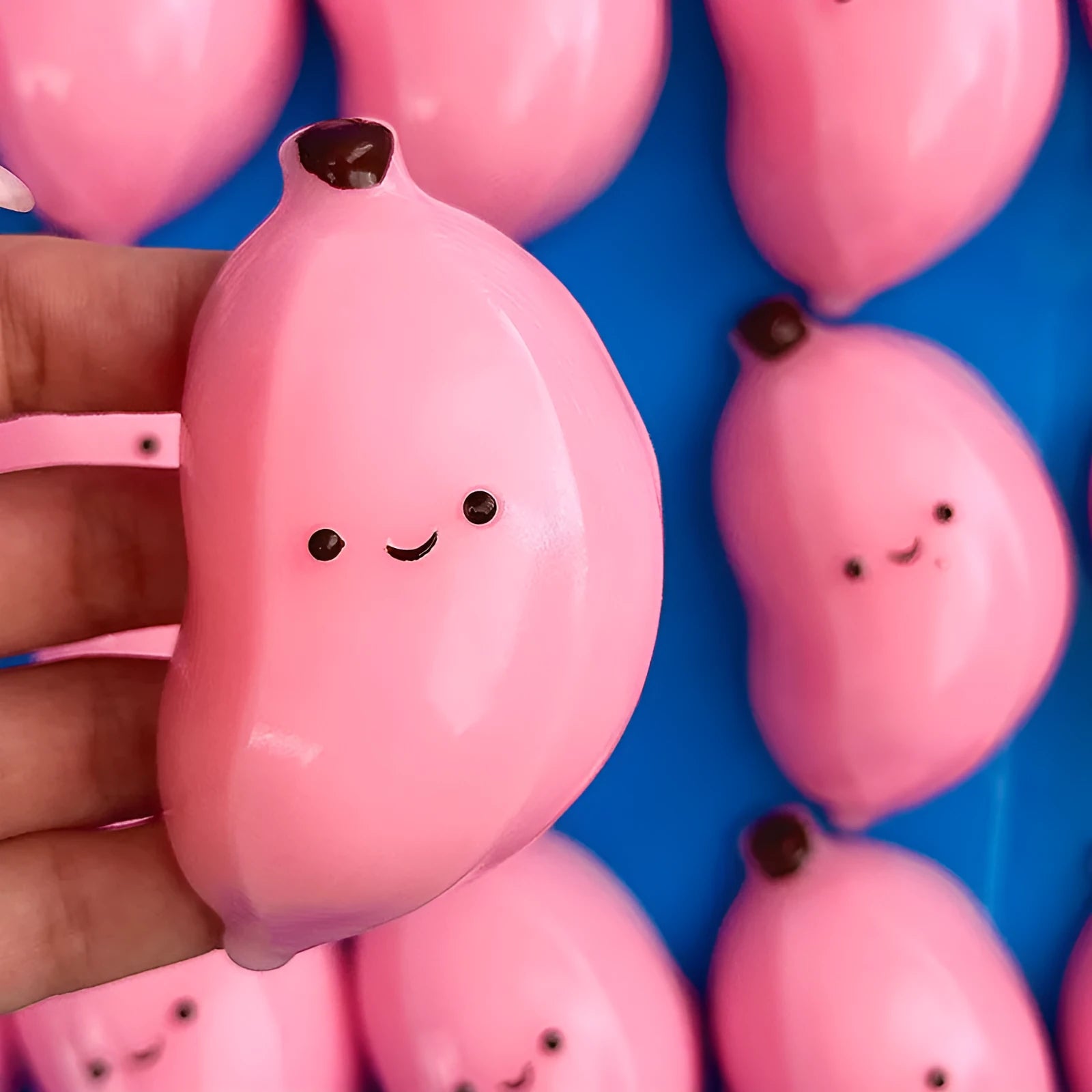 Chubby banana squeezing toy in pink TPR material for stress relief