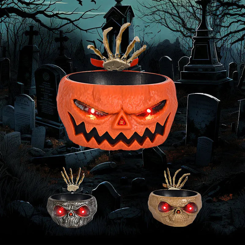 Plastic Halloween pumpkin candy bowl with motion activated skeleton hand, glowing red eyes, in Khaki colour, on a table with candy.