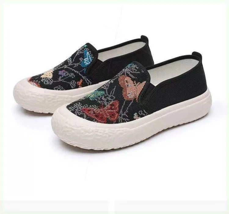 Women's slip-on canvas shoes in Black with round toe and decorative sewing thread details