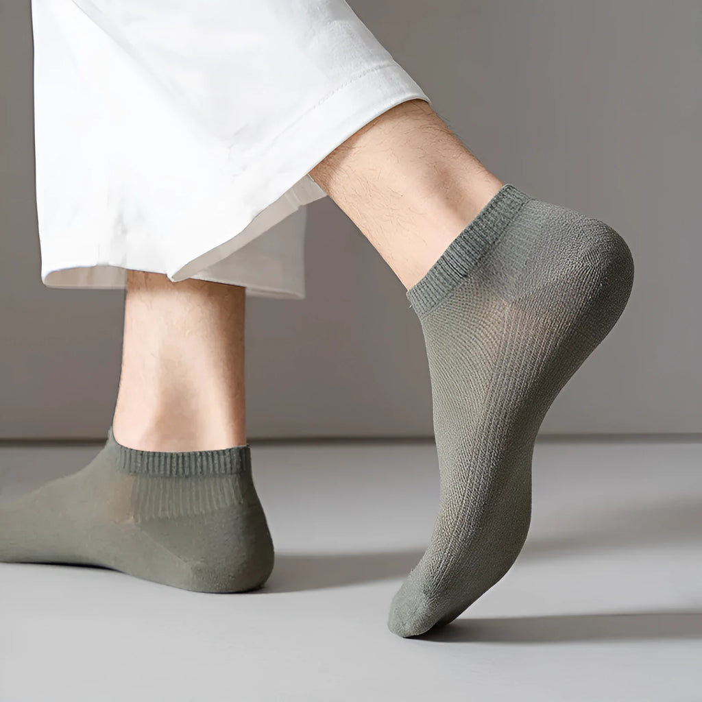 Men's solid colour low-cut polyester boat socks in various colours on white background