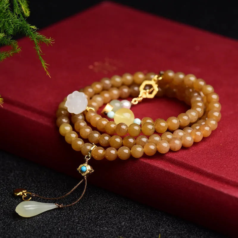 Women's green jade bead bracelet with leaf motifs and sequin details
