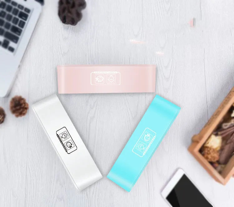 Blue rectangular LED alarm clock with digital display on a table.