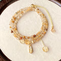 Gold tone women's bracelet with natural caramel coloured citrine crystal and Saturn decorative element