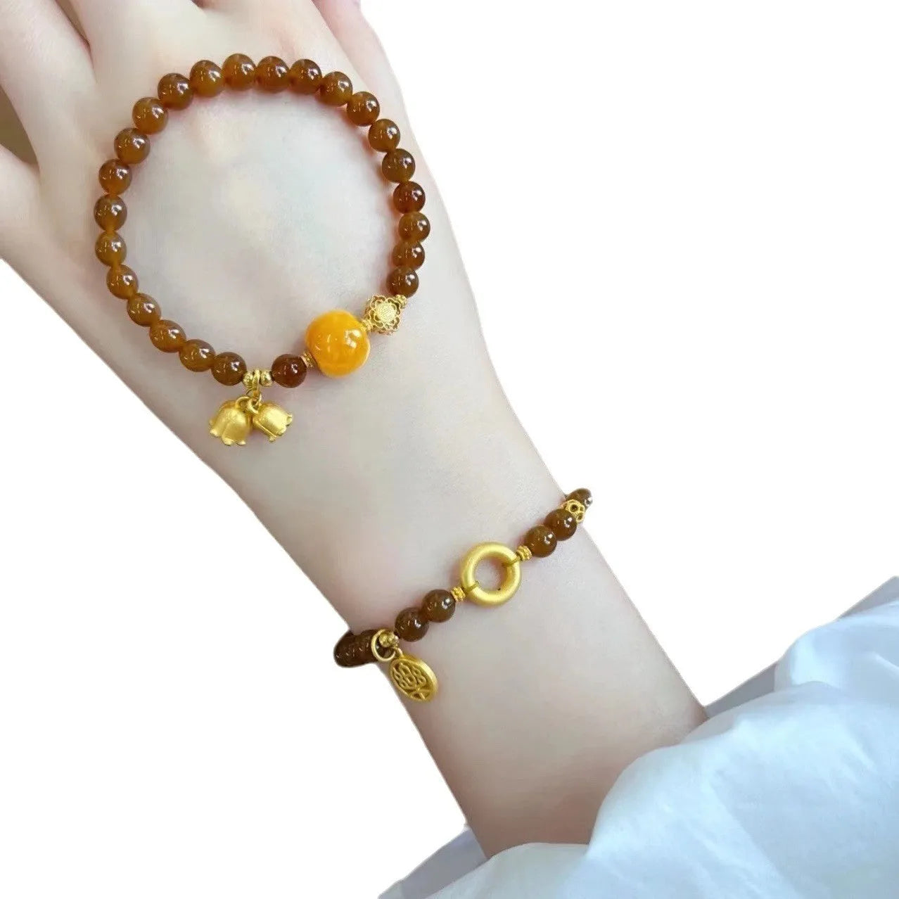 Caramel-coloured women's bracelet with electroplated beeswax finish and lily flower design.