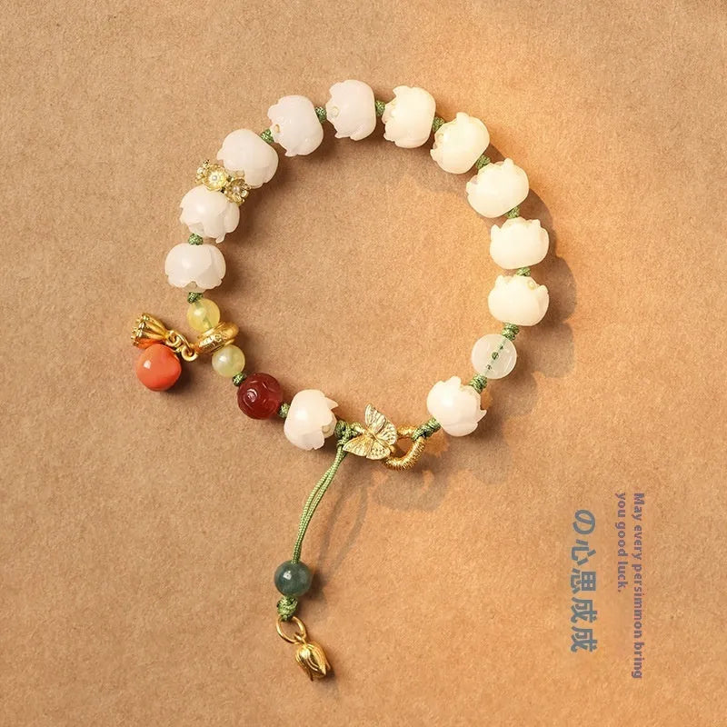 White jade Bodhi bracelet with hand-woven rope, lotus beads, and large pumpkin beads on an open ring design.