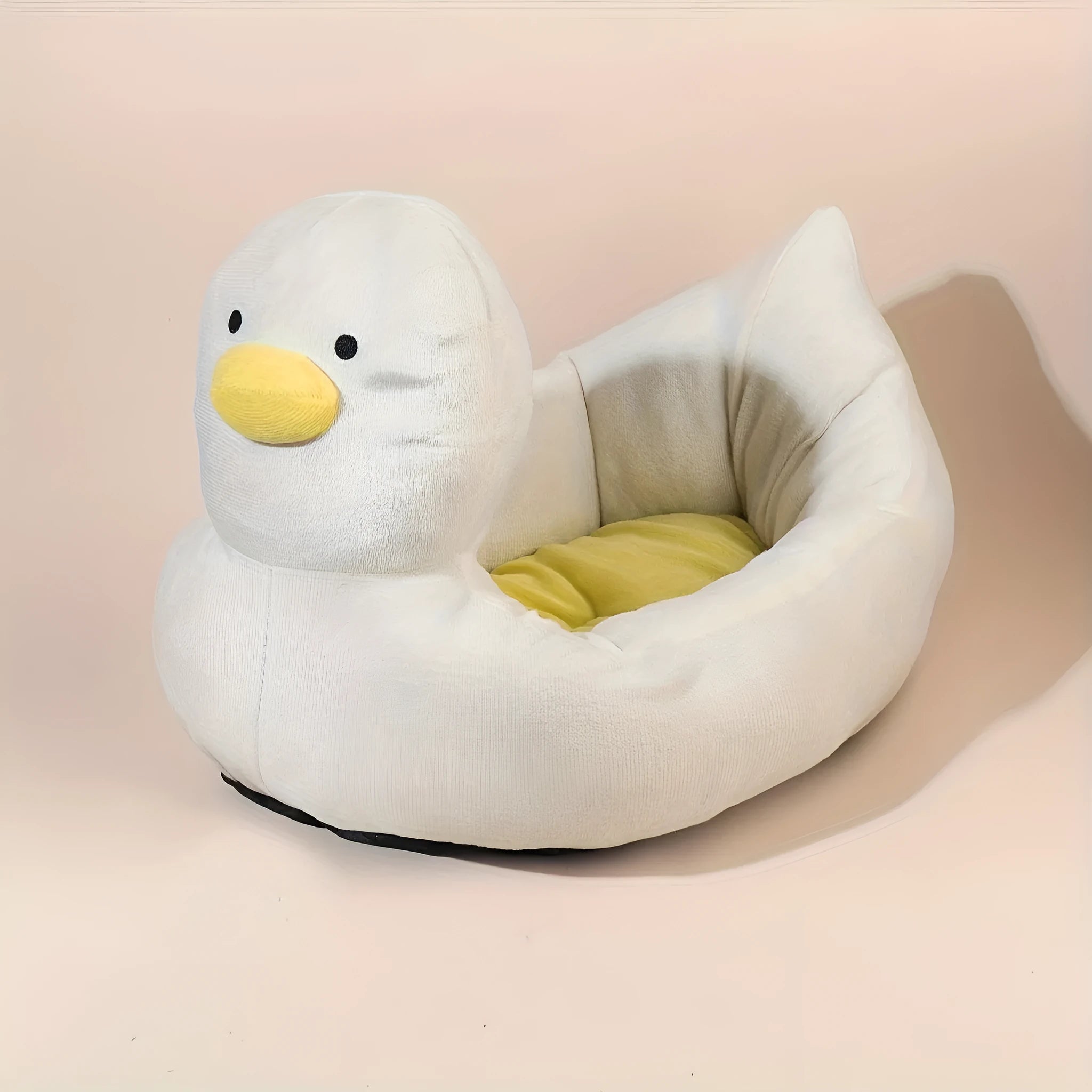 Blue duck-shaped fluffy pet bed for small dogs and cats on a wooden floor.