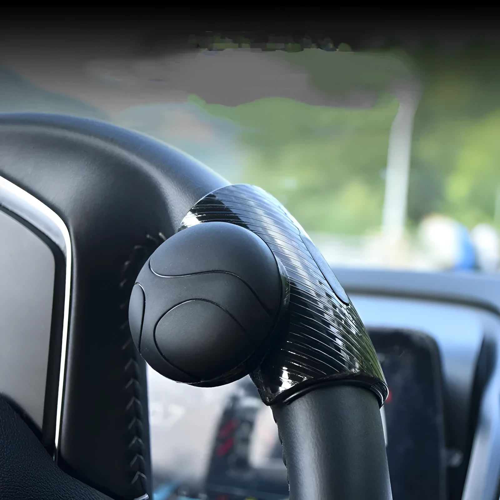 Black and blue steering wheel assist balls showing silicone cover and approximate 9cm by 6cm size
