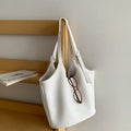 Idle Style light retro PU soft leather large capacity commuter shoulder bag in black with bucket shape and double straps