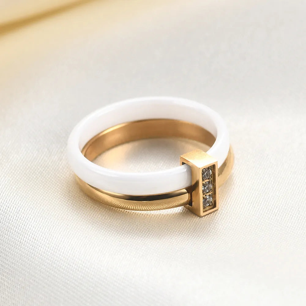 Geometric ceramic women's ring with zirconium inlay and glossy stitching in steel black.