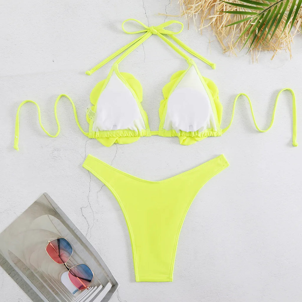 Low waist bikini swimsuit with 3D flower design in solid colour.