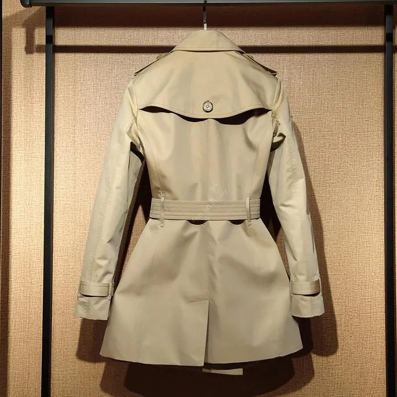 Khaki coloured women's double-breasted British-style trench coat with long flight sleeves.