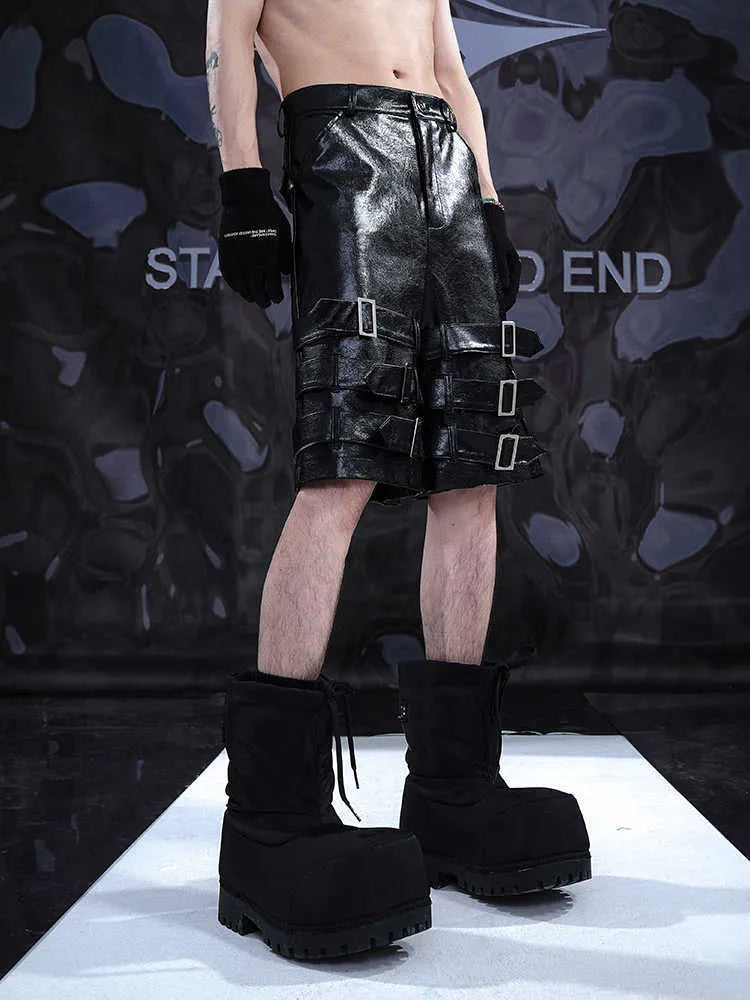 Black men's PU leather casual shorts with ring detailing, shown in a cropped pants style.