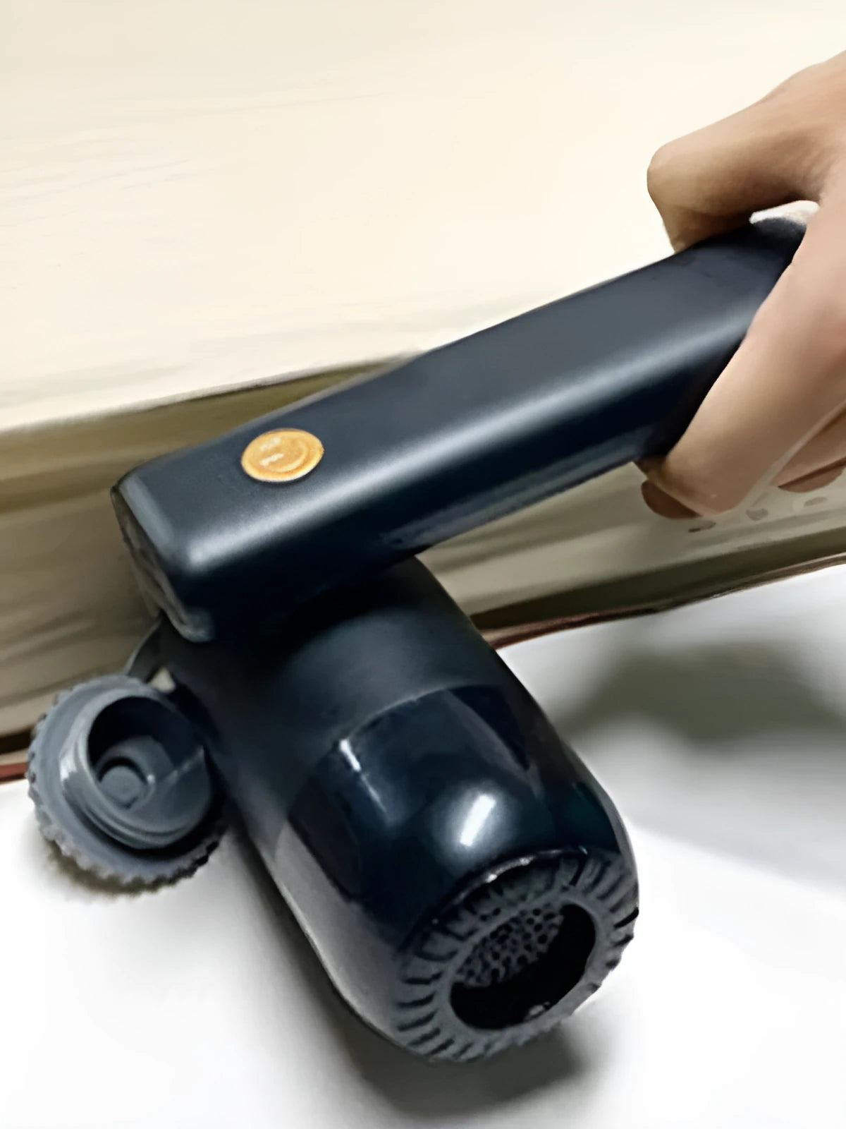 Cordless car vacuum cleaner with 4000mAh battery and replaceable nozzle on black background