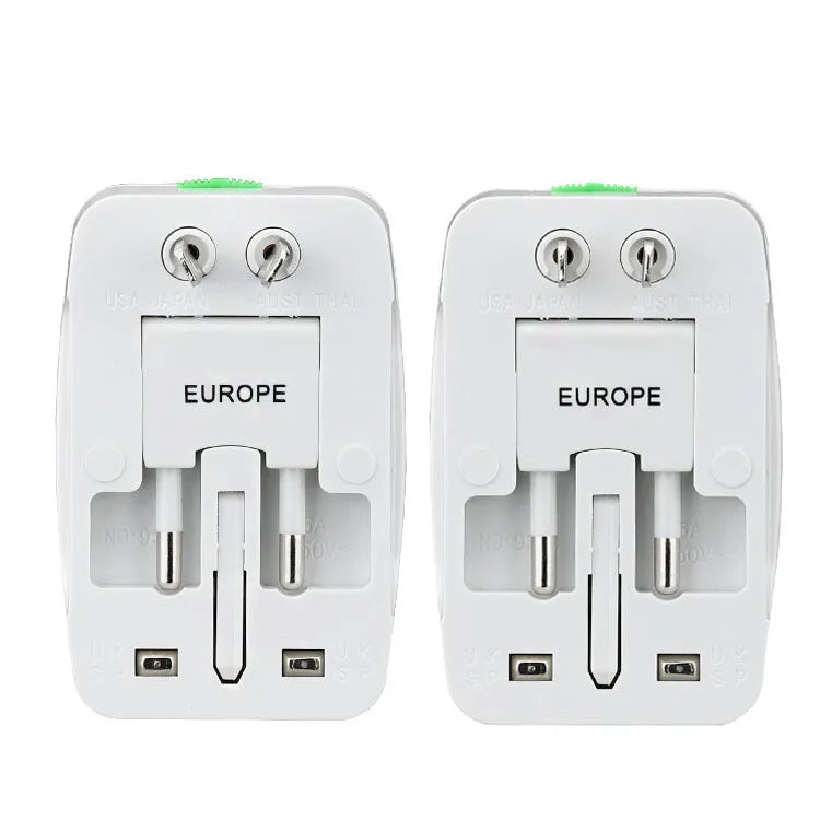 White universal travel plug adapter with dual USB ports and interchangeable UK EU US AU plugs on a plain background