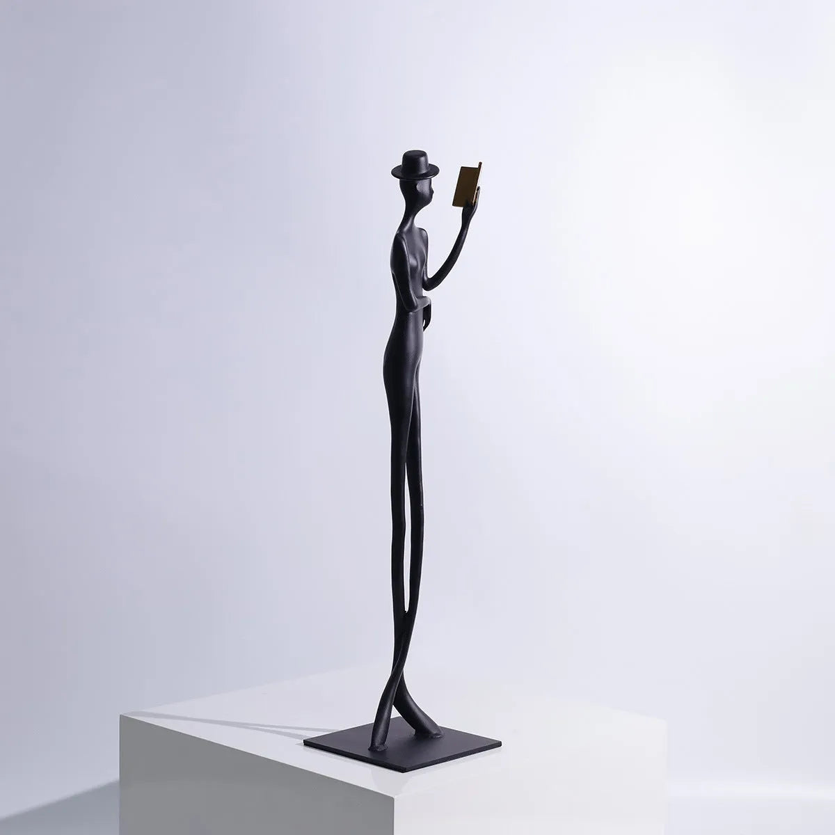 Black cast aluminium desktop sculpture of reading woman measuring 51 cm tall